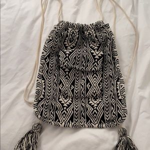 Black and white tapestry backpack with pocket